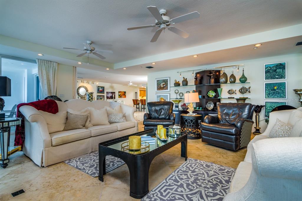 1350 Gulf Boulevard, Unit 901 Clearwater Beach, FL 33767 - Photo 28 of 63 a living room with furniture ceiling fan and a rug
