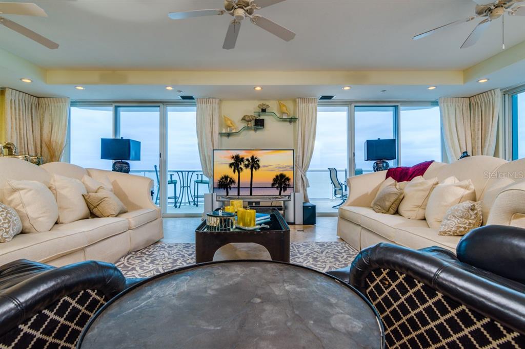 1350 Gulf Boulevard, Unit 901 Clearwater Beach, FL 33767 - Photo 29 of 63 a living room with furniture and a flat screen tv