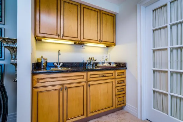 a large living room with stainless steel appliances kitchen island granite countertop a sink and a granite counter tops