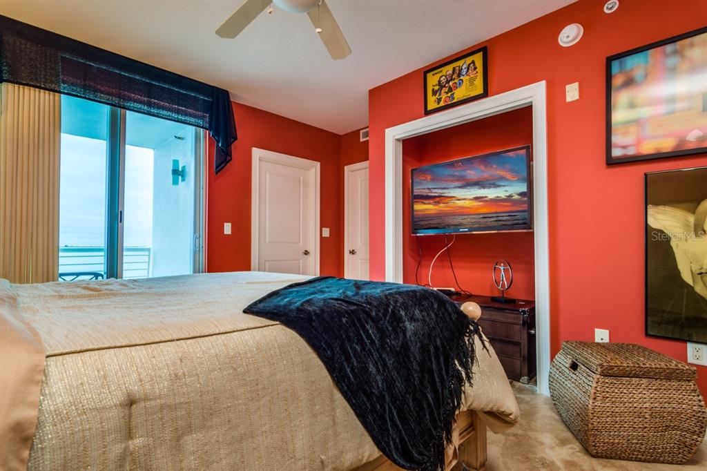 1350 Gulf Boulevard, Unit 901 Clearwater Beach, FL 33767 - Photo 32 of 63 a bedroom with a bed and a painting on the wall