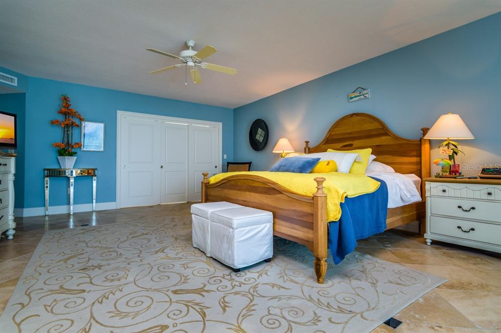 1350 Gulf Boulevard, Unit 901 Clearwater Beach, FL 33767 - Photo 33 of 63 a bedroom with a bed and a ceiling fan