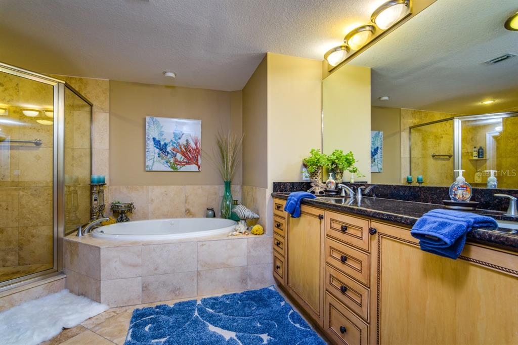 1350 Gulf Boulevard, Unit 901 Clearwater Beach, FL 33767 - Photo 38 of 63 a large living room with stainless steel appliances kitchen island granite countertop a sink and a granite counter tops