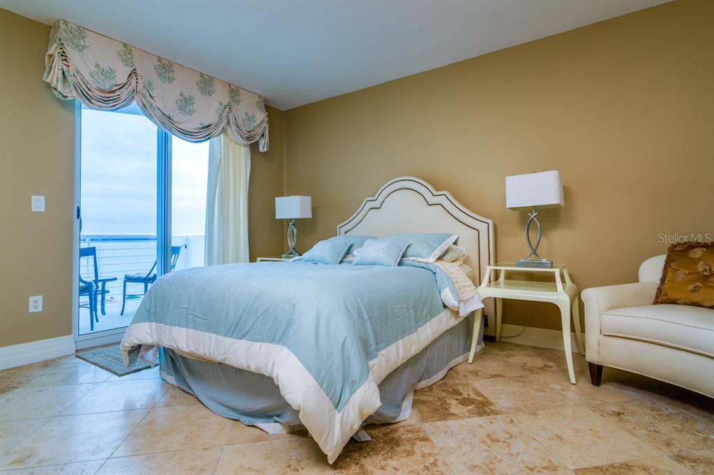 1350 Gulf Boulevard, Unit 901 Clearwater Beach, FL 33767 - Photo 43 of 63 a bedroom with a bed chair and wall painting on the wall