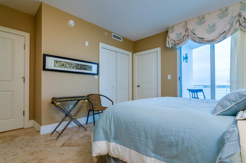 1350 Gulf Boulevard, Unit 901 Clearwater Beach, FL 33767 - Photo 44 of 63 a bedroom with a bed and a dresser in it
