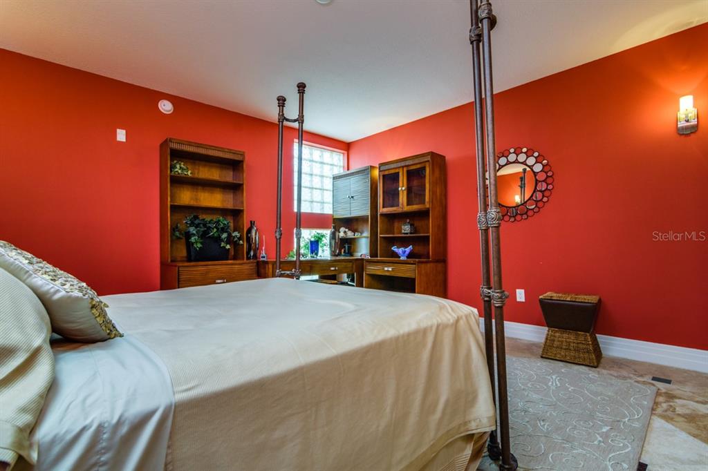 1350 Gulf Boulevard, Unit 901 Clearwater Beach, FL 33767 - Photo 46 of 63 a bed sitting in a bedroom next to a window