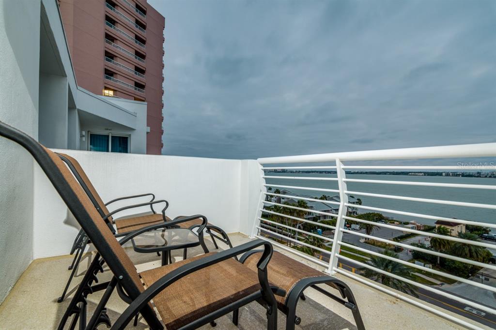 1350 Gulf Boulevard, Unit 901 Clearwater Beach, FL 33767 - Photo 52 of 63 a view of a chair and table in the balcony
