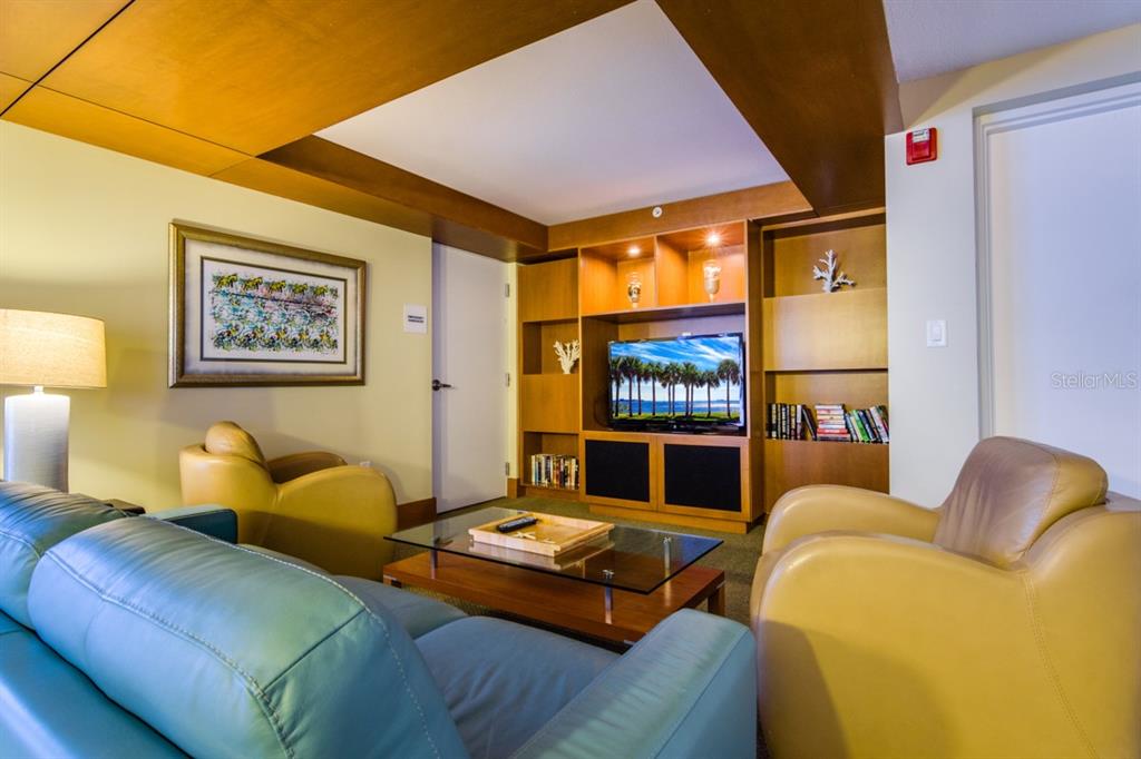 1350 Gulf Boulevard, Unit 901 Clearwater Beach, FL 33767 - Photo 60 of 63 a living room with furniture and a flat screen tv