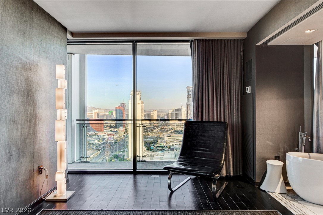 4381 West Flamingo Road, Unit 3002 Las Vegas, NV 89103 - Photo 48 of 59 Floor-to-ceiling glass doors open to a private balcony overlooking the city skyline.