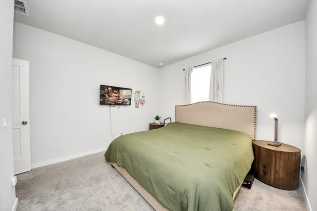 a bedroom with a bed and window