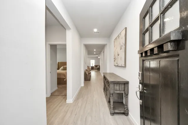 a hallway with a dining table and chairs