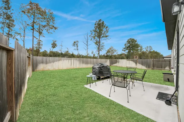 a view of a chair and table on the garden