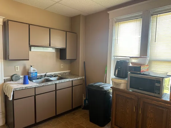 a kitchen with a sink cabinets and window