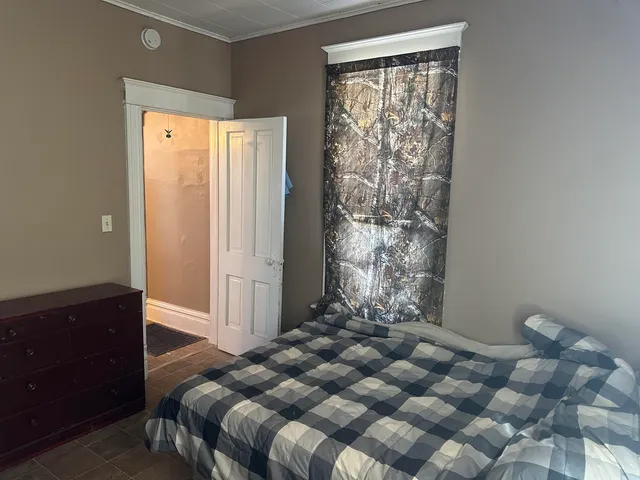 a bedroom with a bed and a dresser