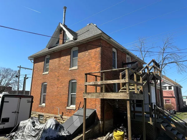 a view of a house with a wooden deck