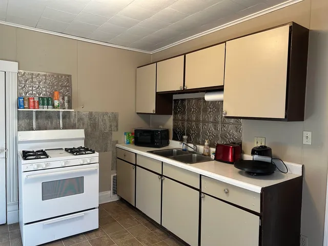 a kitchen with a sink stove and microwave