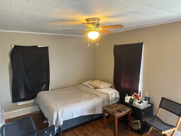 a bedroom with a bed and a chandelier