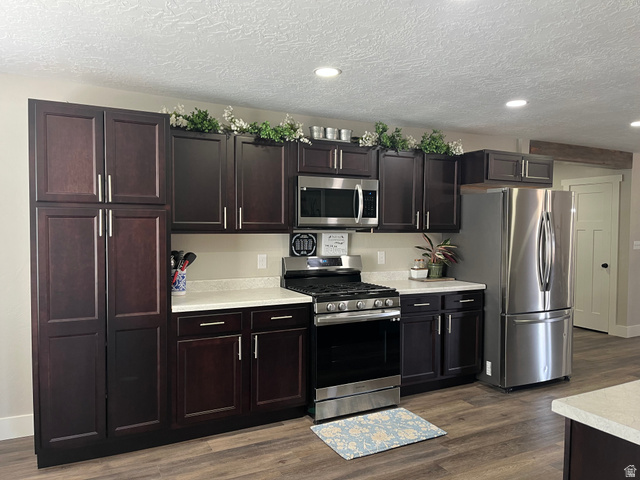 558 North N Cres Road Roosevelt, UT 84066 - Photo 30 of 31 Kitchen featuring dark wood-finish cabinetry, stainless steel appliances, and wood-finish flooring