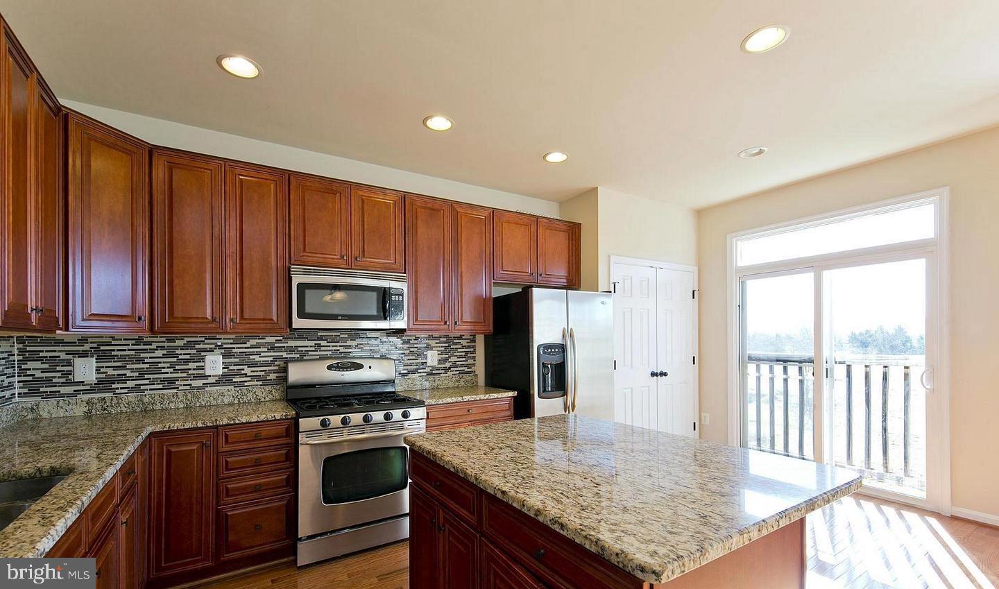73 Spoon Square Front Royal, VA 22630 - Photo 5 of 28 a kitchen with stainless steel appliances granite countertop a stove a sink dishwasher a refrigerator and a microwave
