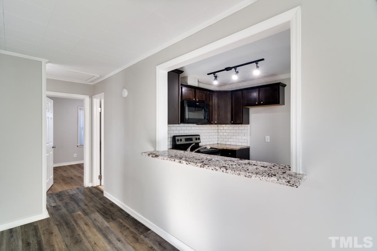 213 Angier Avenue Raleigh, NC 27610 - Photo 11 of 38 a view of a kitchen cabinets and a wooden floor