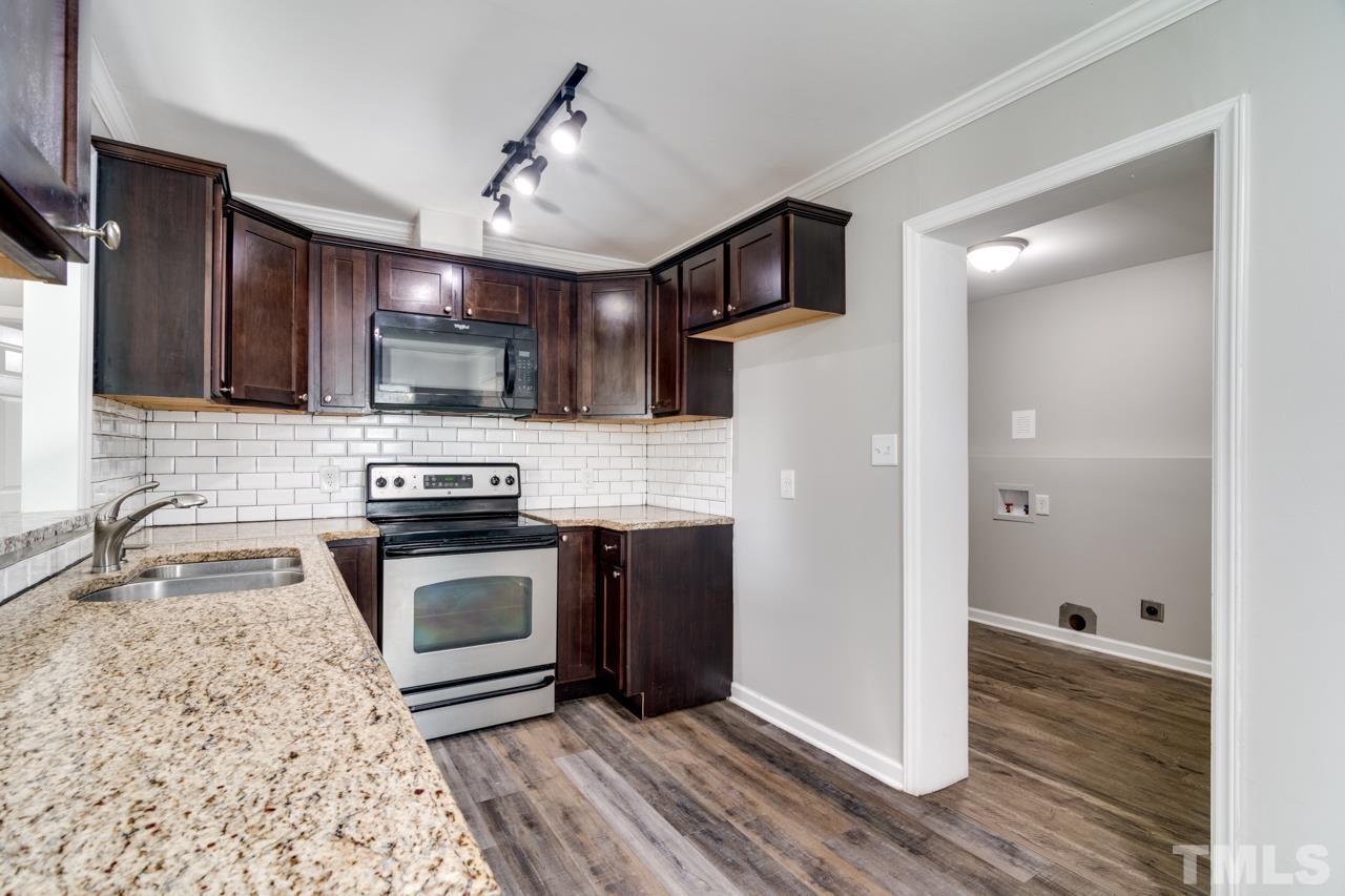 213 Angier Avenue Raleigh, NC 27610 - Photo 17 of 38 a kitchen with stainless steel appliances granite countertop a refrigerator a stove a sink and a microwave