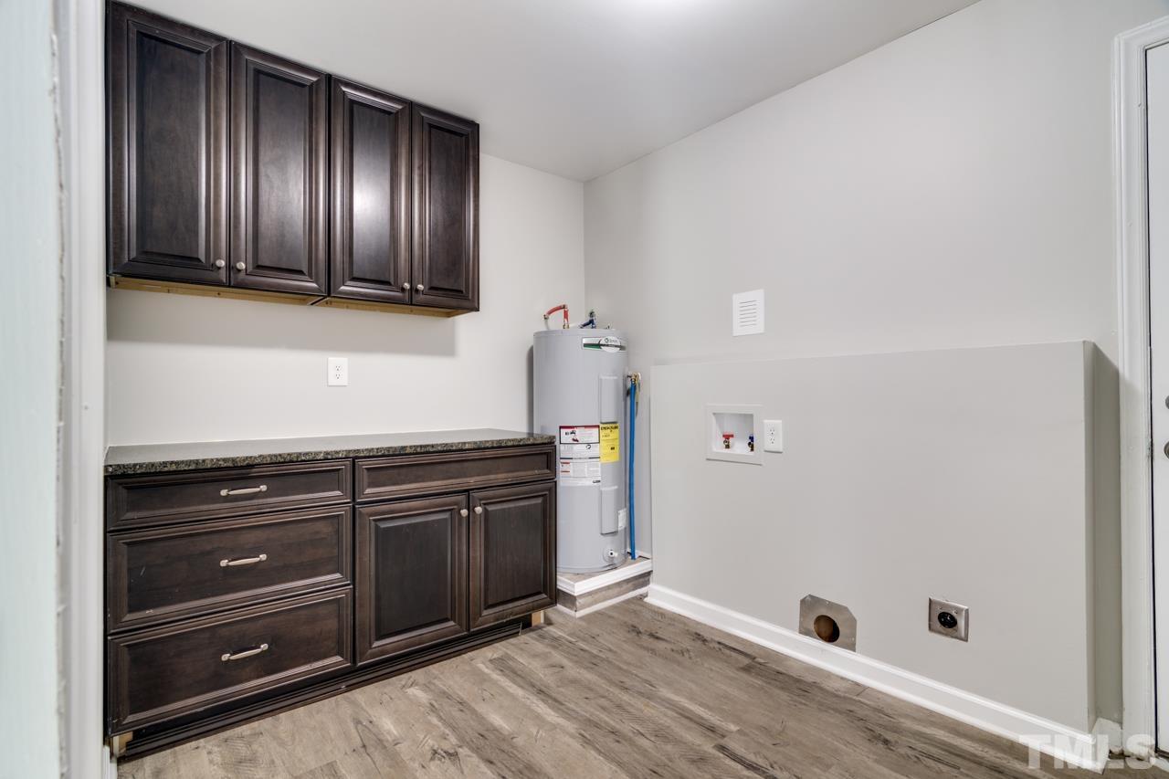 213 Angier Avenue Raleigh, NC 27610 - Photo 18 of 38 a room with hard wood floors and cabinets