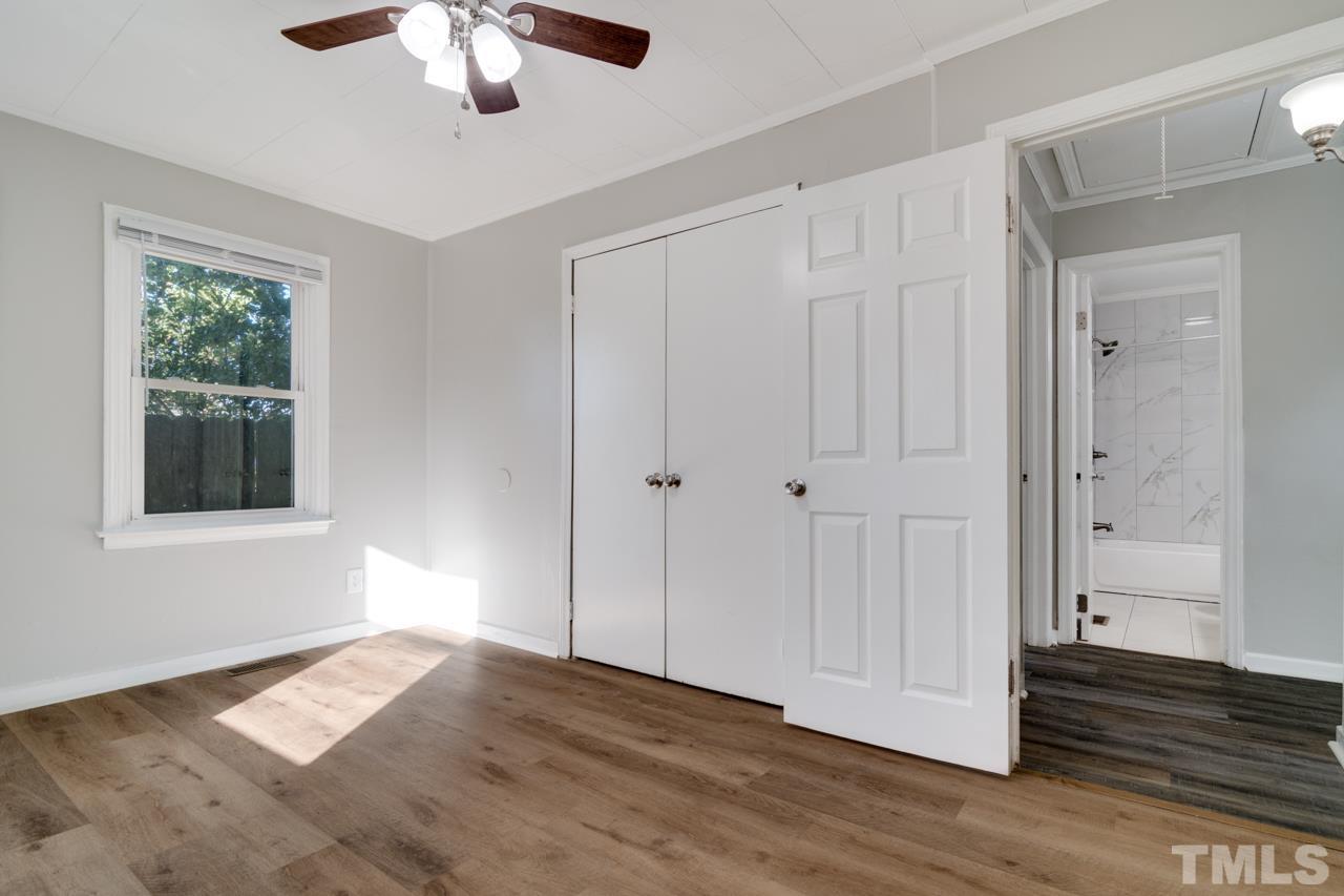 213 Angier Avenue Raleigh, NC 27610 - Photo 25 of 38 a view of an empty room with wooden floor and a window
