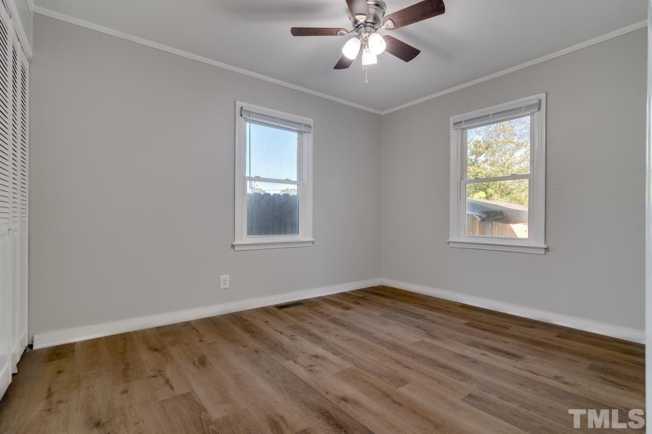 213 Angier Avenue Raleigh, NC 27610 - Photo 26 of 38 a view of an empty room with wooden floor and a window