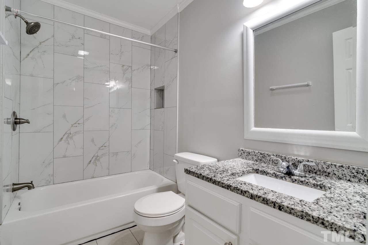 213 Angier Avenue Raleigh, NC 27610 - Photo 28 of 38 a bathroom with a granite countertop sink toilet and shower