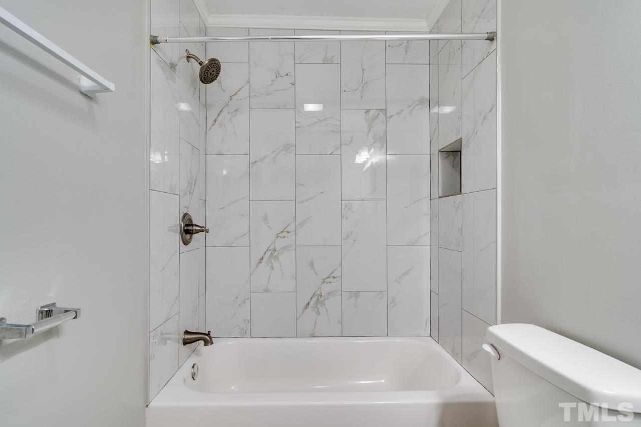 213 Angier Avenue Raleigh, NC 27610 - Photo 29 of 38 a bathroom with a shower and a toilet