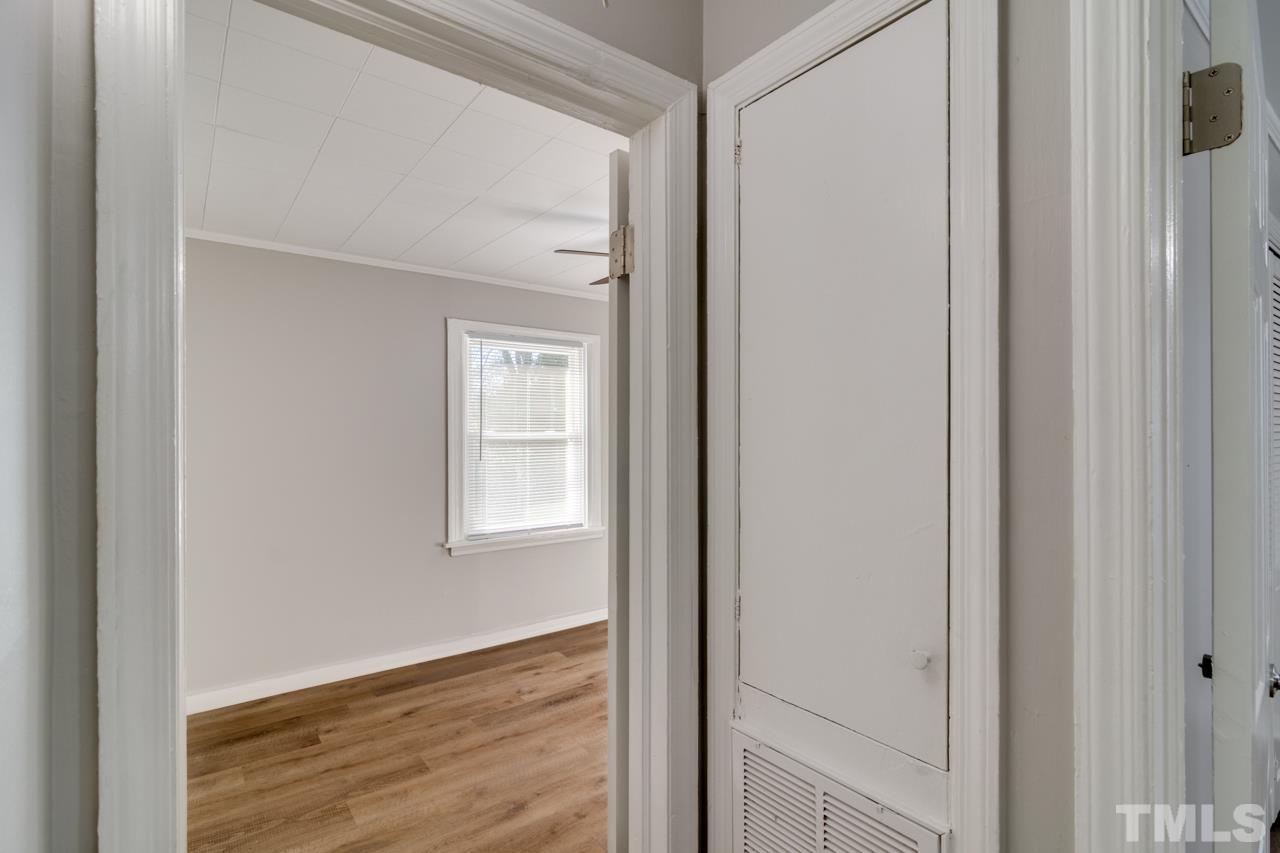 213 Angier Avenue Raleigh, NC 27610 - Photo 32 of 38 a view of an empty room with wooden floor and a window