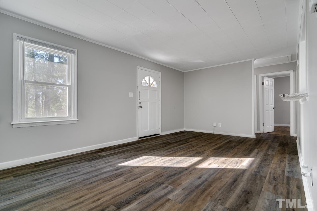 213 Angier Avenue Raleigh, NC 27610 - Photo 5 of 38 a view of a room with wooden floor and window
