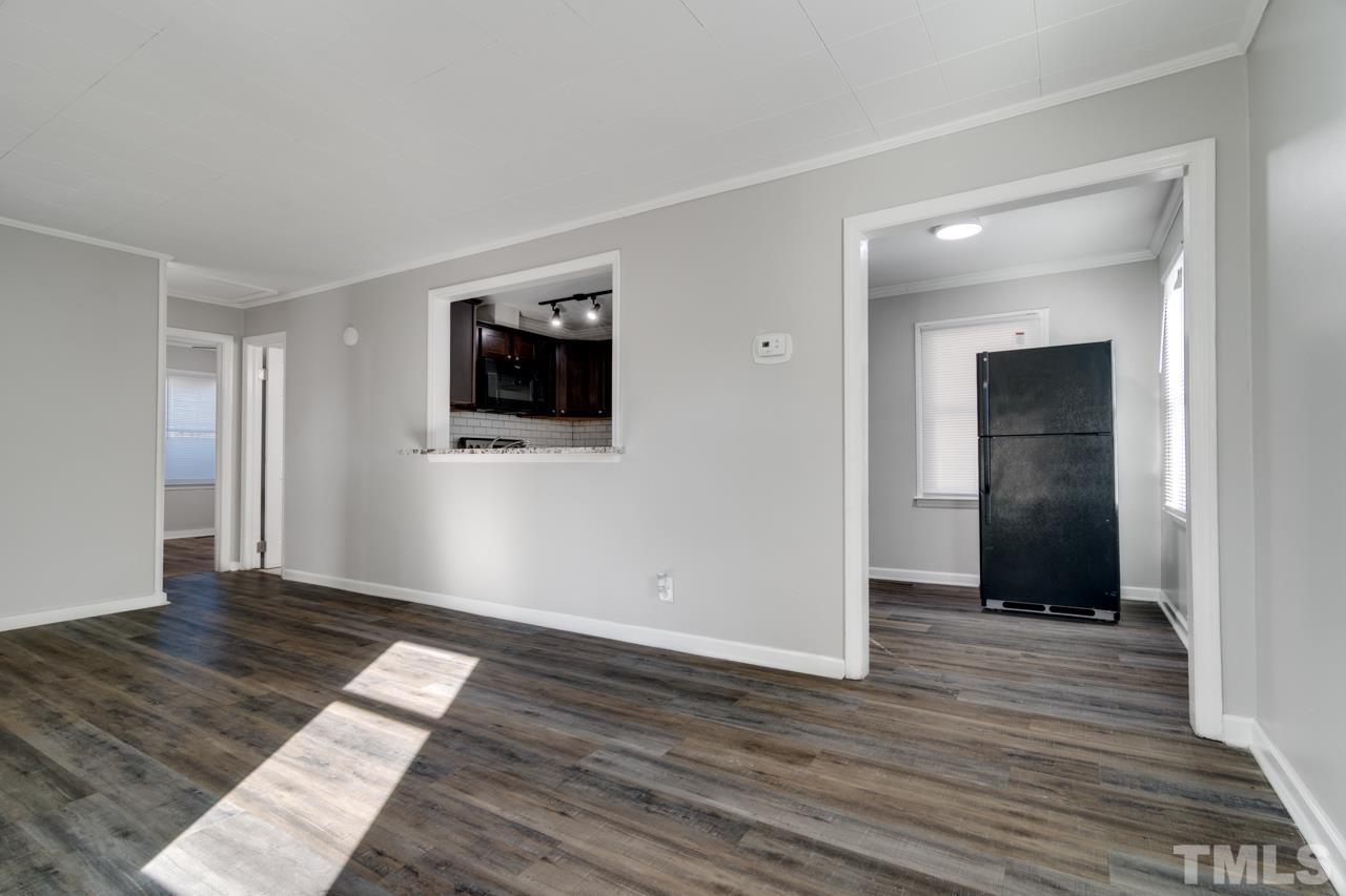 213 Angier Avenue Raleigh, NC 27610 - Photo 8 of 38 a view of a livingroom with wooden floor and a flat screen tv