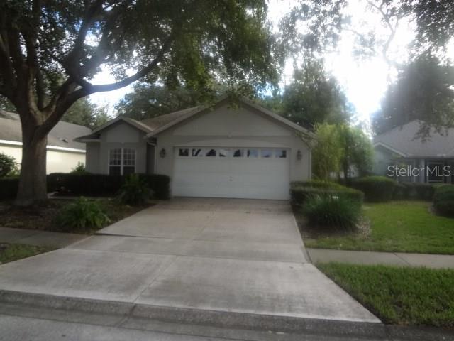 6020 Spring Creek Court Mount Dora, FL 32757 - Photo 1 of 1 a front view of a house with a yard and garage