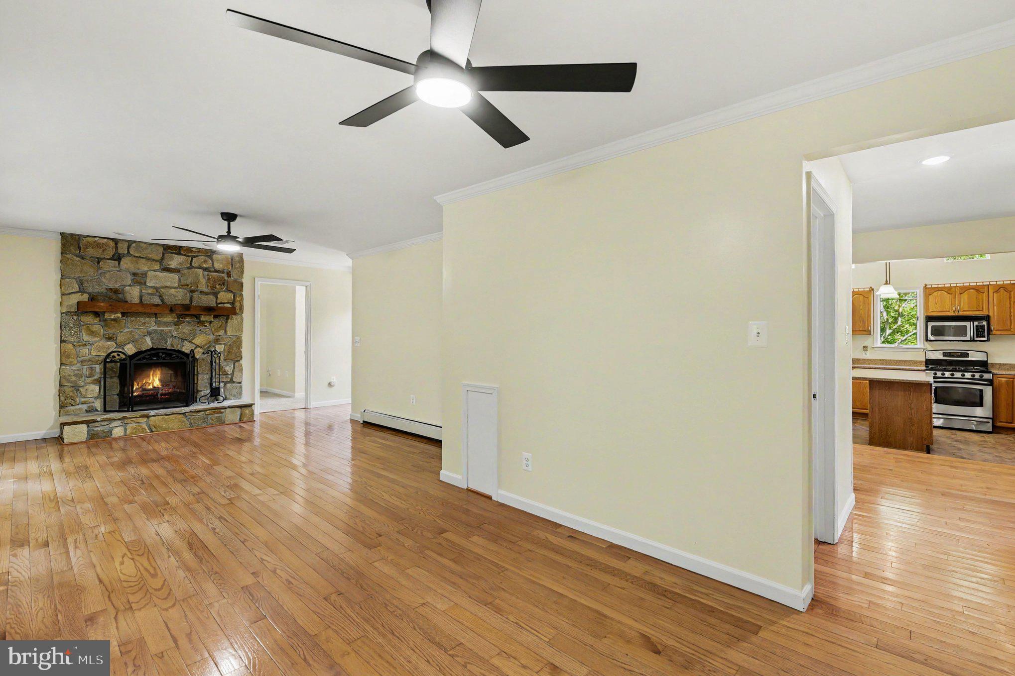 7627 A Chapman Road Kingsville, MD 21087 - Photo 14 of 40 Living room w/wood fireplace