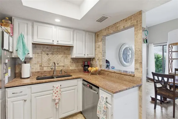 a kitchen with a sink a stove and a cabinets