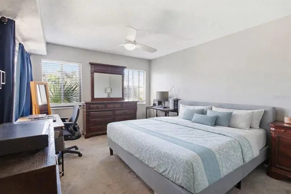 a bedroom with a bed and a large window