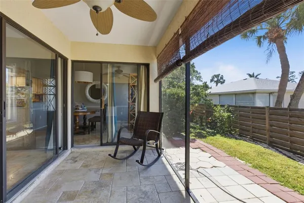 a view of a porch with chairs and couches with wooden floor