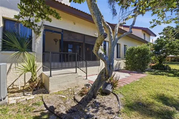 a view of a house with a tree in the background