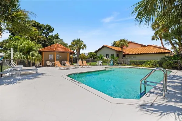 an outdoor space with pool and furniture