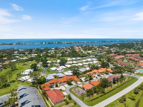 an aerial view of residential houses with outdoor space