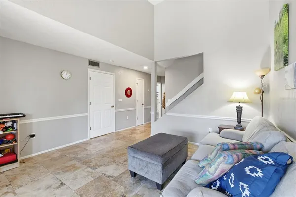 a living room with furniture and a lamp