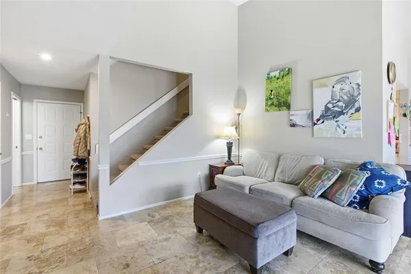 a living room with furniture and a painting
