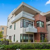 a view of a white building among the front of a house