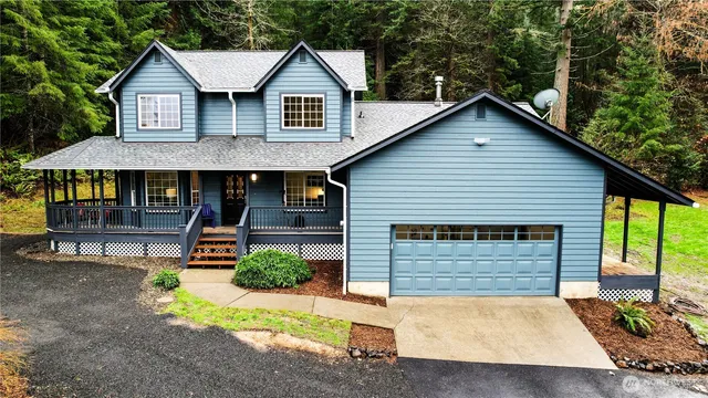 a view of house with outdoor space area and wooden fence