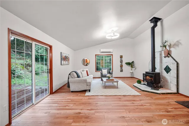 a living room with furniture large window and flat screen tv