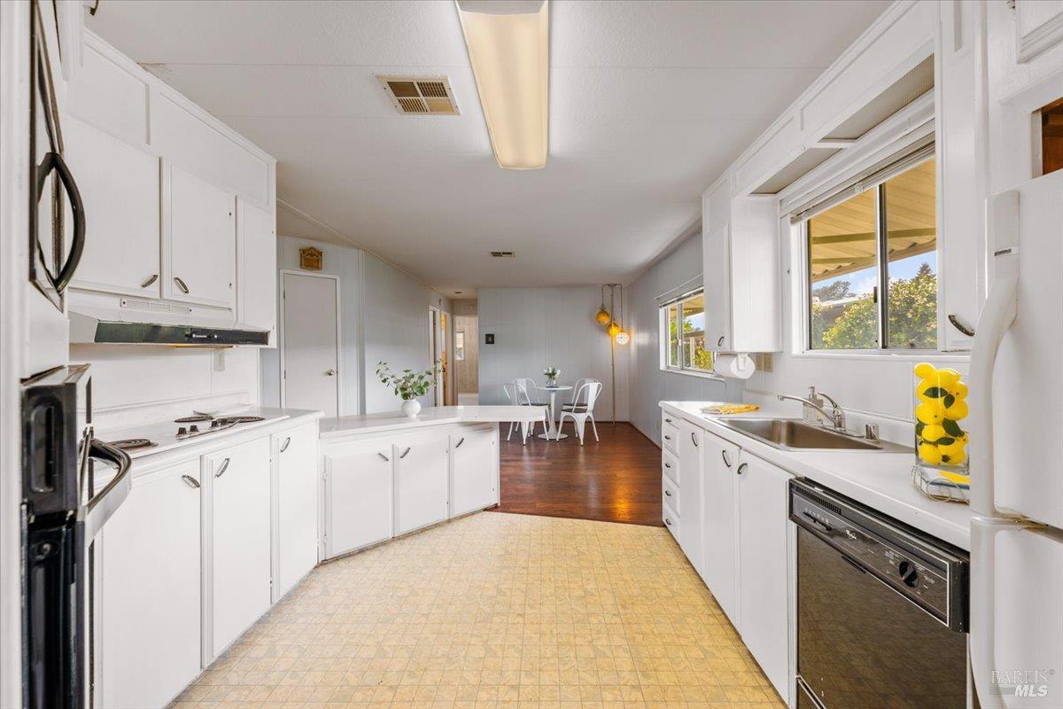 243 Parque Cabana Rohnert Park, CA 94928 - Photo 10 of 26 a kitchen with stainless steel appliances a stove a sink and a refrigerator