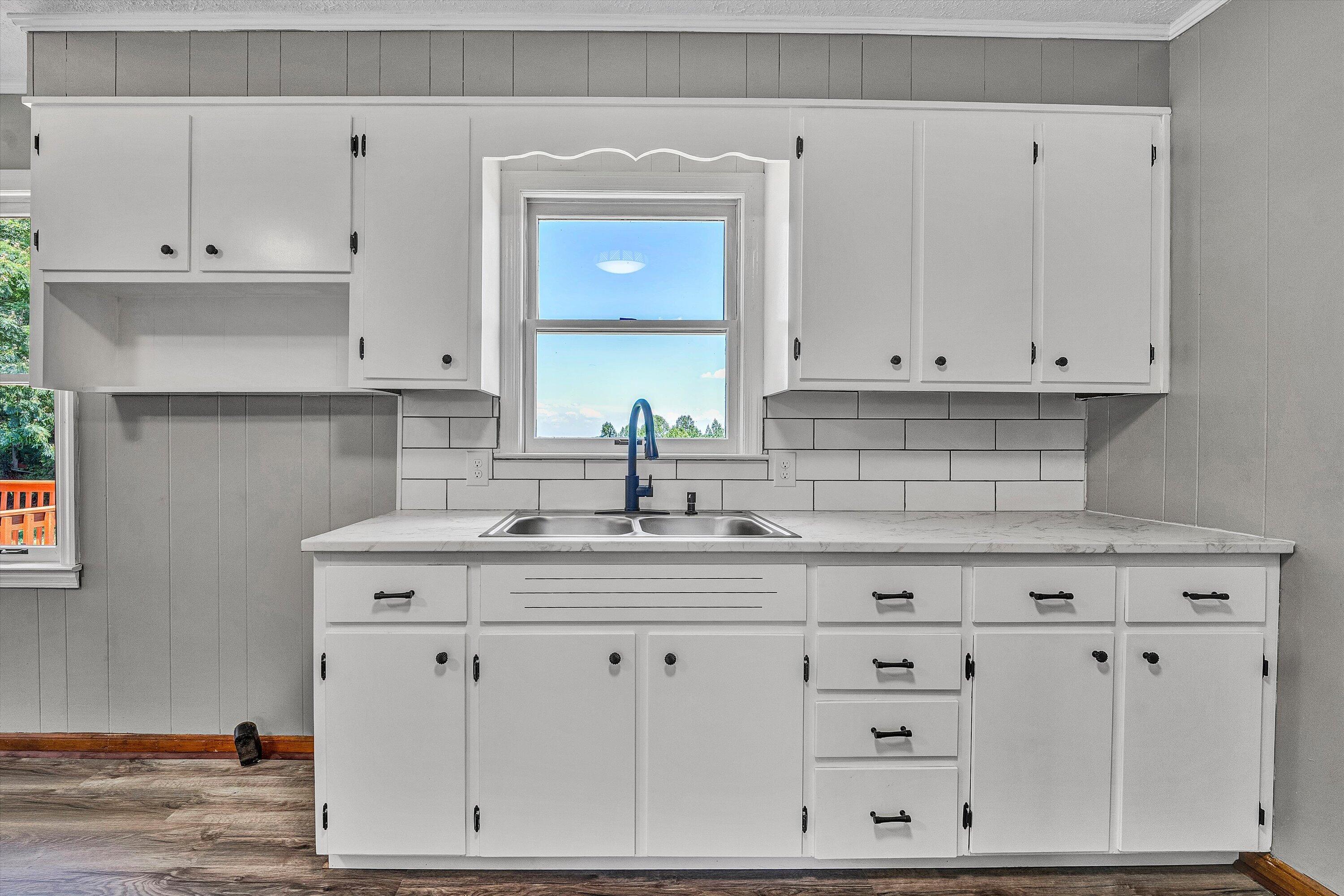 602 Power Dam Road Rocky Mount, VA 24151 - Photo 11 of 34 a kitchen with white cabinets and white appliances