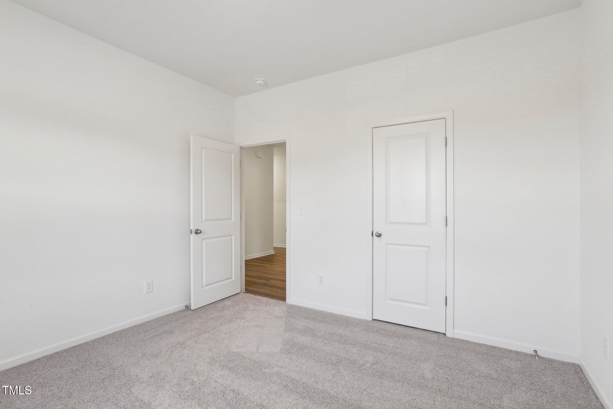 899 Embraer Way Spring Spring Hope, NC 27882 - Photo 16 of 43 a view of an empty room and closet area