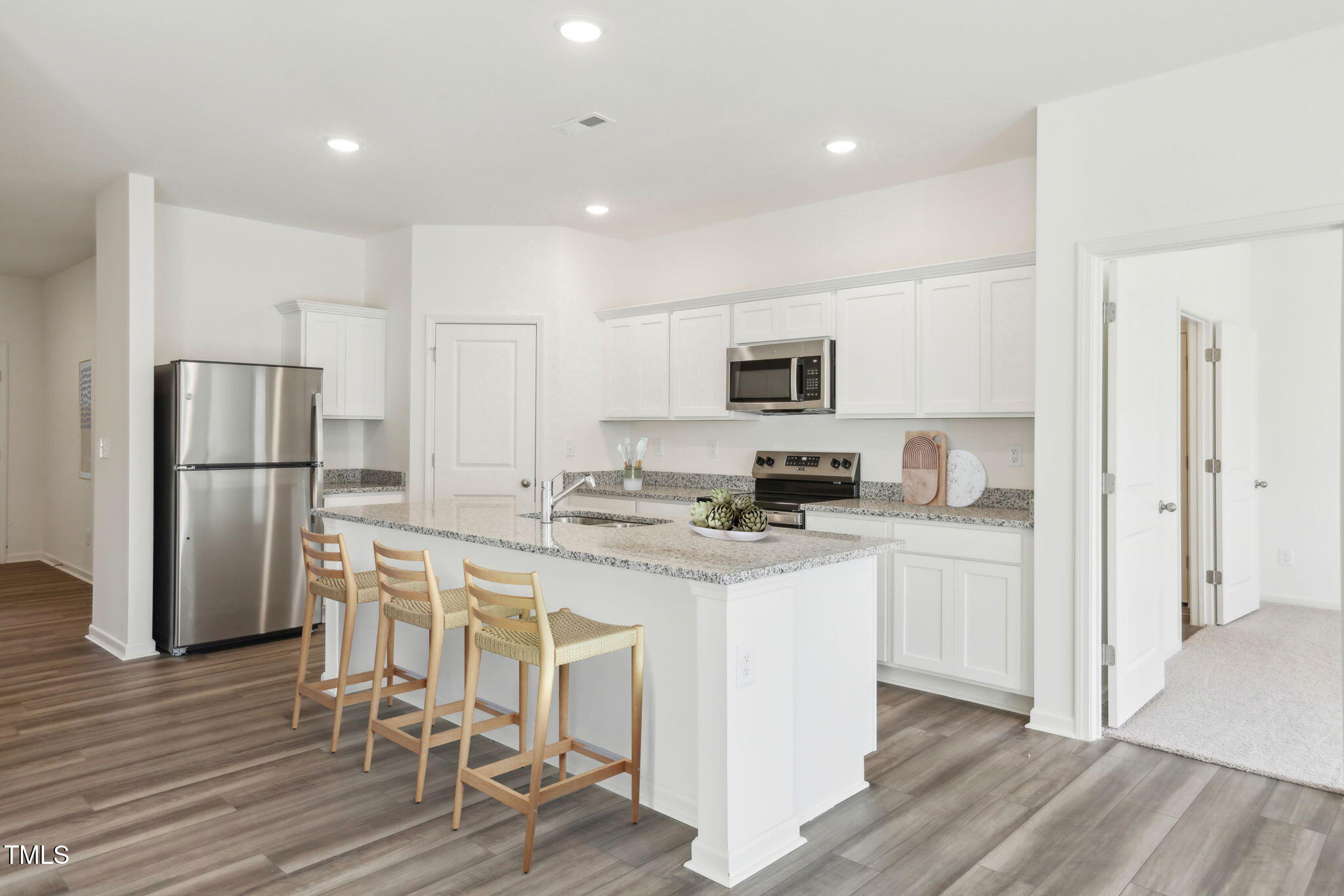 899 Embraer Way Spring Spring Hope, NC 27882 - Photo 25 of 43 a kitchen with stainless steel appliances a refrigerator stove microwave and cabinets