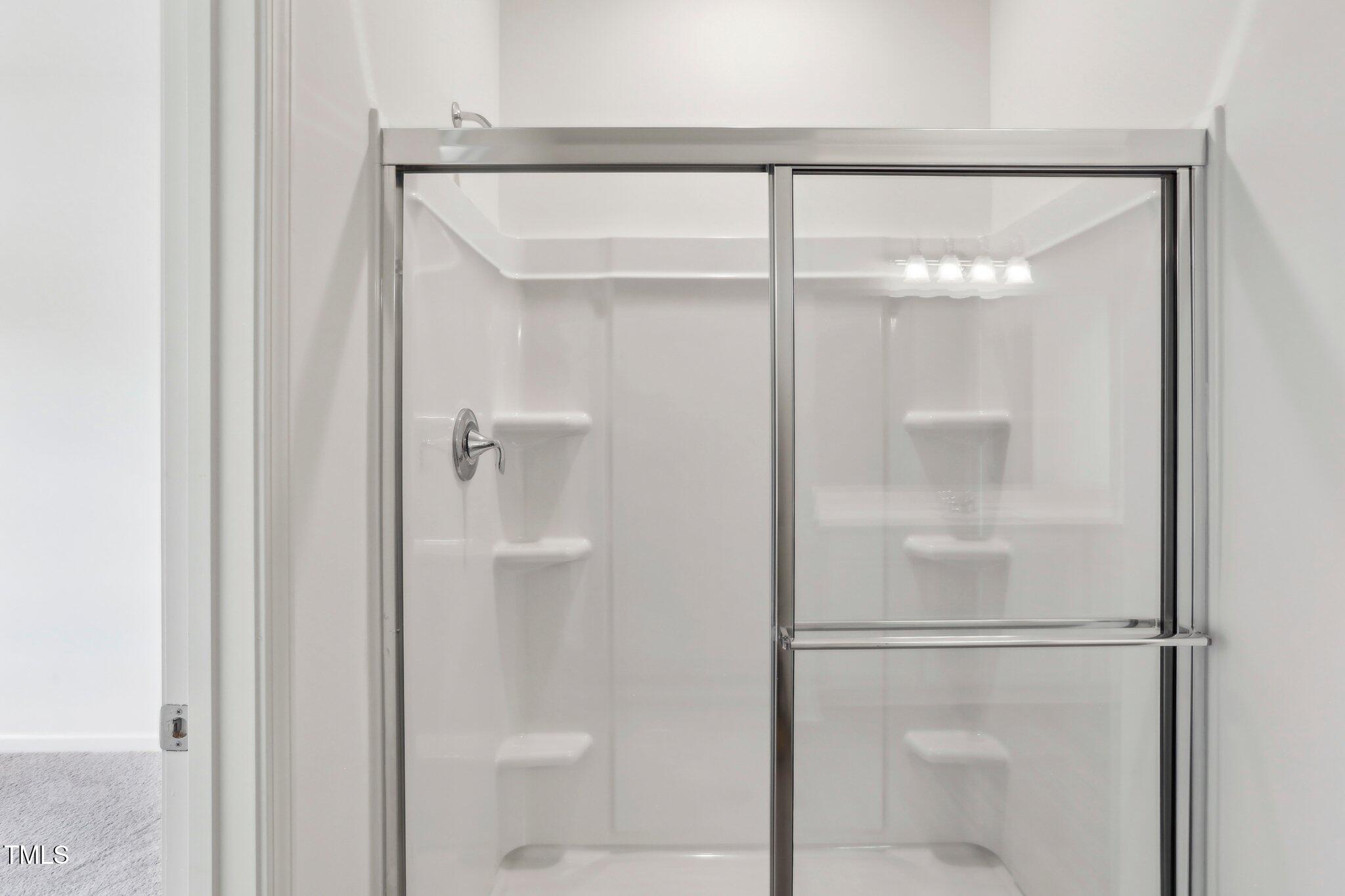 899 Embraer Way Spring Spring Hope, NC 27882 - Photo 38 of 43 a bathroom with a glass shower door